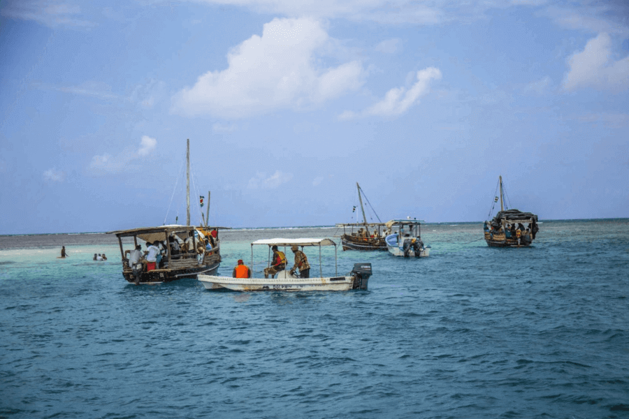 Wasini island visitors at cristal-clear waters of kisite Mtungitu Wasini Island tour boats and visitors